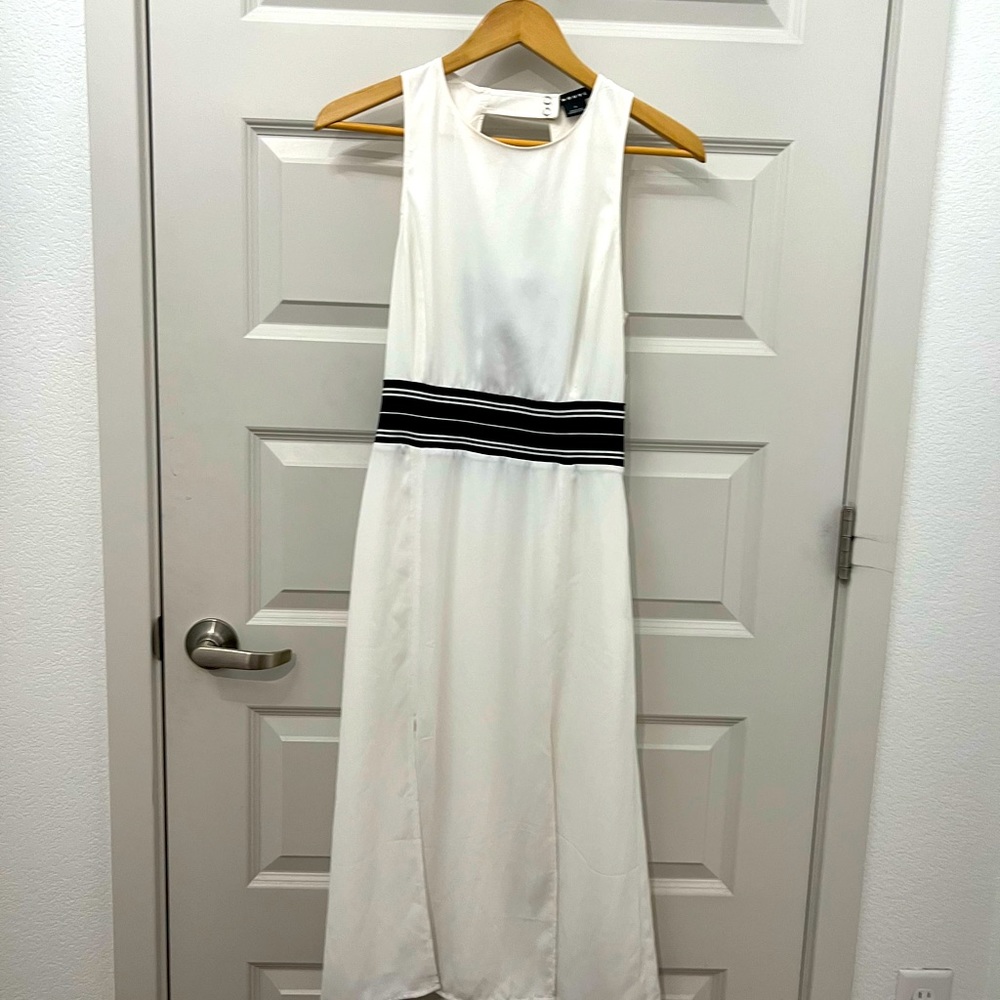 White tea length dress with dark navy band in back